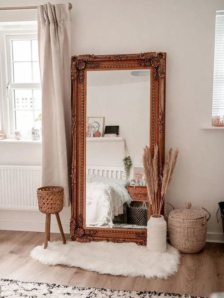 A thrifted mirror brings affordable flair to this minimalist bedroom